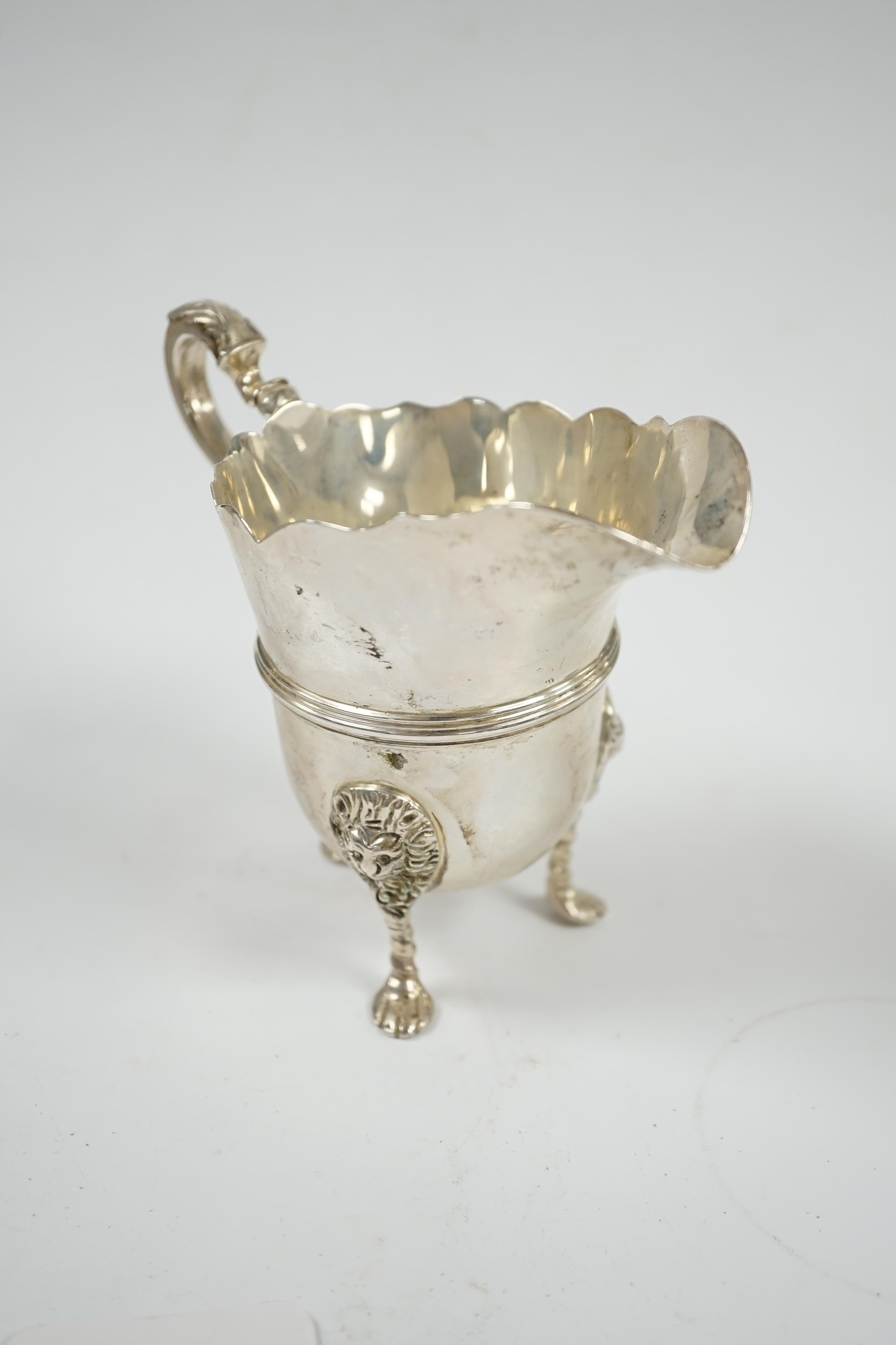 A George V silver cream jug, London 1911, height 11.5cm, 8.1oz. Condition - fair to good